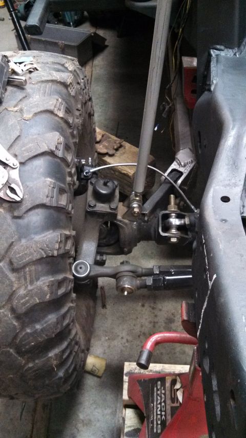 1967 Ford F-250 - Undercarriage view shows the steering and suspension components of a modified truck, possibly undergoing a build or repair.