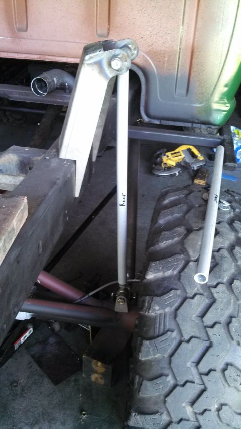 1967 Ford F-250 - Detail of truck frame and suspension components, with a power tool visible in the background.
