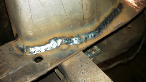1967 Ford F-250 - Newly welded seam on a rusty metal frame, likely part of a vehicle chassis.