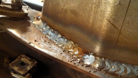 1967 Ford F-250 - Detail of a metal joint showing the results of welding, including weld beads and splatter.