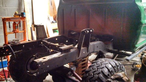 1967 Ford F-250 - The frame and lower cab of a 1967 Ford F-250 are visible in a workshop setting.