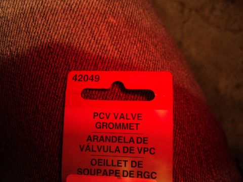 2004 Mercury Grand Marquis - This is a photo of a PCV valve grommet part. The packaging has text in multiple languages.