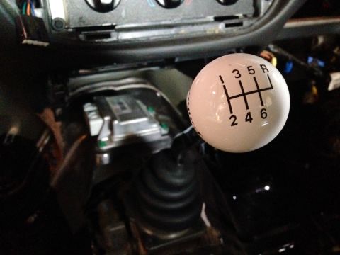2004 Ford Crown Victoria - Close-up of a white 6-speed manual shift knob with gear pattern visible.