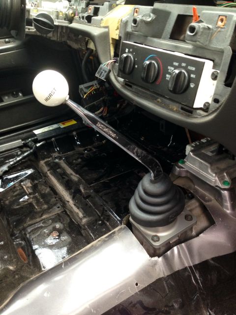 2004 Ford Crown Victoria - Interior view of a car's dashboard and floor, with a Hurst shifter prominently displayed.