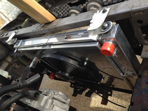 2004 Ford Crown Victoria - Aftermarket aluminum radiator and electric fan assembly installed in a vehicle's engine bay.