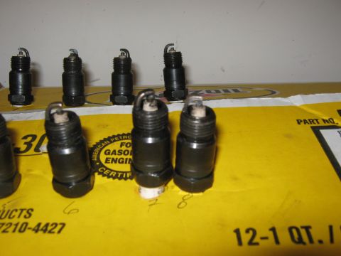 1996 Ford Bronco - Several spark plugs are laid out on a yellow box with visible text and part numbers.