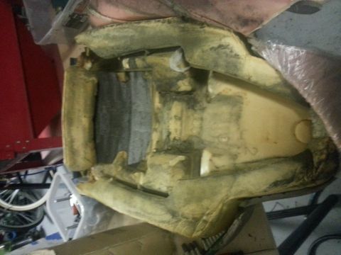 1994 Ford Bronco - The internal frame and foam of a vehicle seat are visible, suggesting it is a replacement part or undergoing repair.