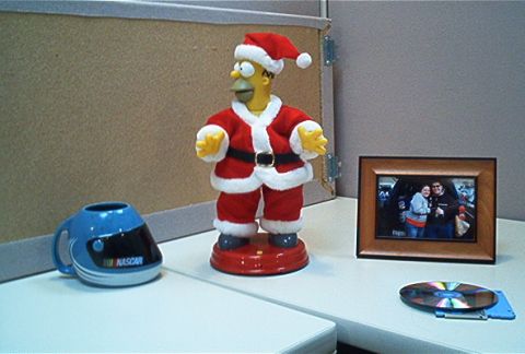 1985 Ford LTD Crown Victoria - Desk items include a Homer Simpson Santa figure, NASCAR mug, framed photo, CD, and floppy disk.