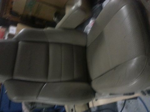 1994 Ford Bronco - Close-up of a tan leather car seat, likely from an older model vehicle.