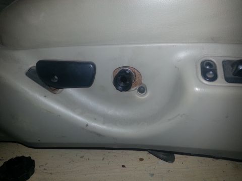 1994 Ford Bronco - Close-up of a car seat's side panel, showing adjustment controls and a visible bolt.