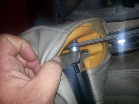 1994 Ford Bronco - Close-up of vehicle seat upholstery and internal mechanism being inspected.
