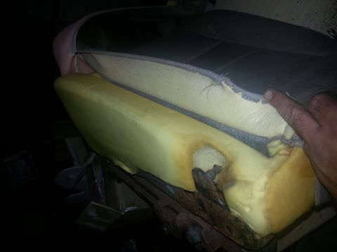 1994 Ford Bronco - Close-up of damaged car seat foam with exposed springs and upholstery.