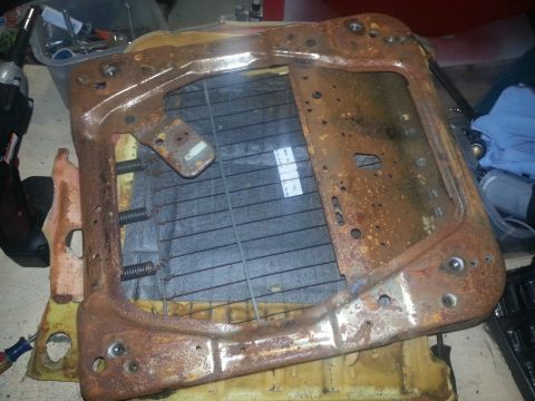 1994 Ford Bronco - A heavily rusted seat frame is shown, with springs and some fabric still attached.