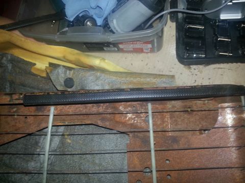 1994 Ford Bronco - Close-up of a car seat frame showing rust and foam padding, with tools in the background.