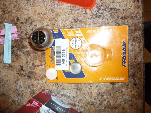 2007 Subaru Impreza - A GReddy shift knob is shown in its retail packaging on a speckled countertop.