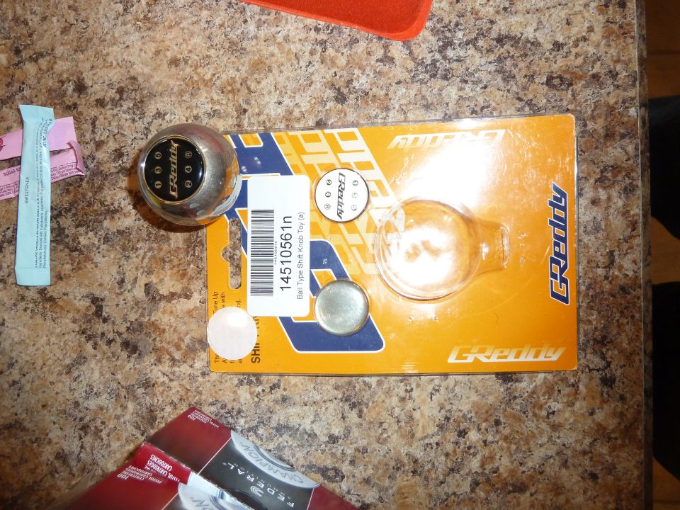 GReddy shift knob in orange and yellow packaging with part number 14510561n