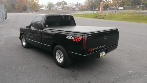 1990 Chevrolet Silverado 1500 - This black 1990 Chevrolet Silverado 1500 pickup truck features a tonneau cover and distinctive 454 SS badging.