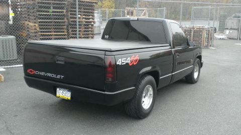 1990 Chevrolet Silverado 1500 - This black 1990 Chevrolet Silverado 1500 is shown from the rear 3/4 view, "454 SS" badging on the fender.