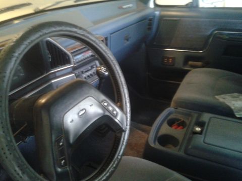 1988 Ford Bronco - Interior view of a 1988 Ford Bronco, the steering wheel, dashboard, and seating area.