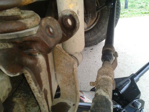 1988 Ford Bronco - Close-up of the front suspension system on a 1988 Ford Bronco, showing the shock and spring assembly.