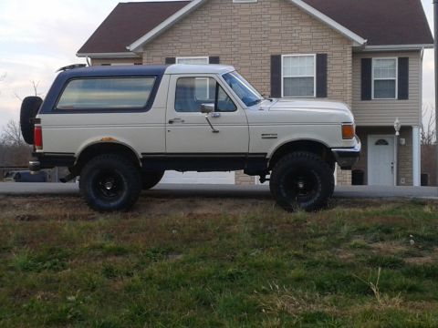 1988 Ford Bronco - This 1988 Ford Bronco is seen from the side, a two-tone paint scheme and a spare tire mounted on the rear.