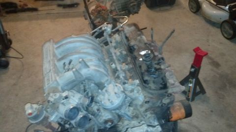 1988 Ford Bronco - Engine assembly is shown with various components attached, resting on a support stand.