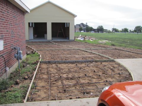 1995 Ford Bronco - A new driveway is being prepared for concrete, with a brick house and garage visible.