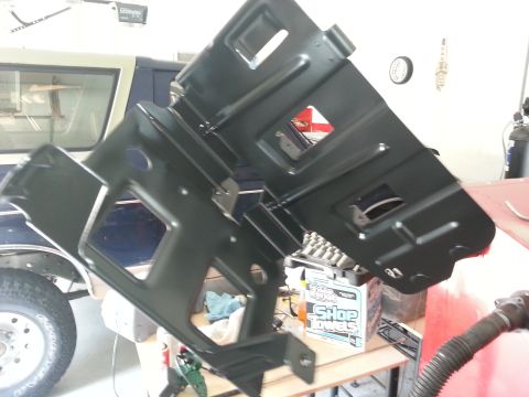 1994 Ford Bronco - A black air intake part is shown, likely for a 1994 Ford Bronco, with a vehicle visible in the background.