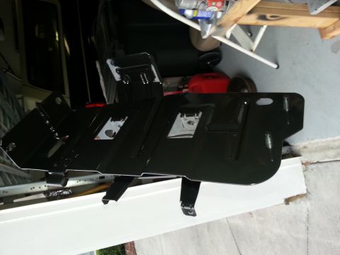 1994 Ford Bronco - A black metal part with several cutouts and mounting brackets is shown.