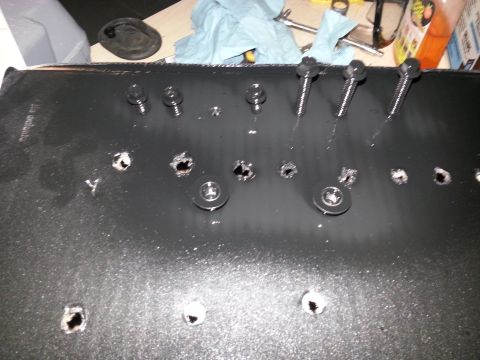 1994 Ford Bronco - A black automotive part with multiple bolt holes and fasteners is shown, with a SuperMotors logo in the corner.