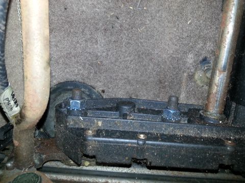1994 Ford Bronco - A close-up view of a vehicle's interior mechanical component, likely part of the seat or floor mechanism.