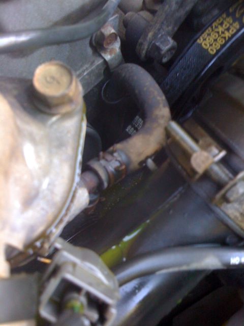 1991 Mazda Miata - Close-up of a coolant hose in an engine bay, showing some wear and tear. Text on a nearby belt reads '4PK960'.