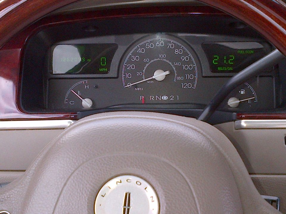 Car dashboard with speedometer, odometer showing 126209 miles, and fuel economy display
