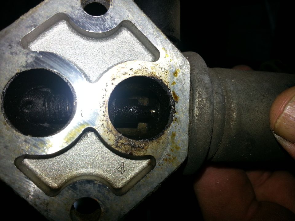 Throttle body with two circular openings, one marked with a '4'