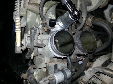 1994 Ford Bronco - Throttle body assembly with attached components and hoses.