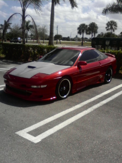 1994 Ford Probe - This 1994 Ford Probe is parked in a lot under a partly cloudy sky.