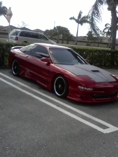 1994 Ford Probe - This 1994 Ford Probe is seen in a parking lot with a contrasting grey hood and aftermarket wheels.