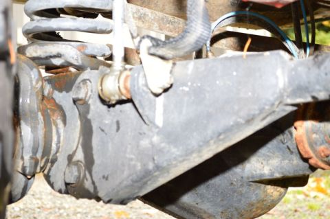 1989 Ford Bronco - Detail shot of vehicle suspension components, showing rust and wear.