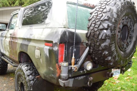 1989 Ford Bronco - This 1978 Ford Bronco features a camouflage paint job and a rear-mounted spare tire.