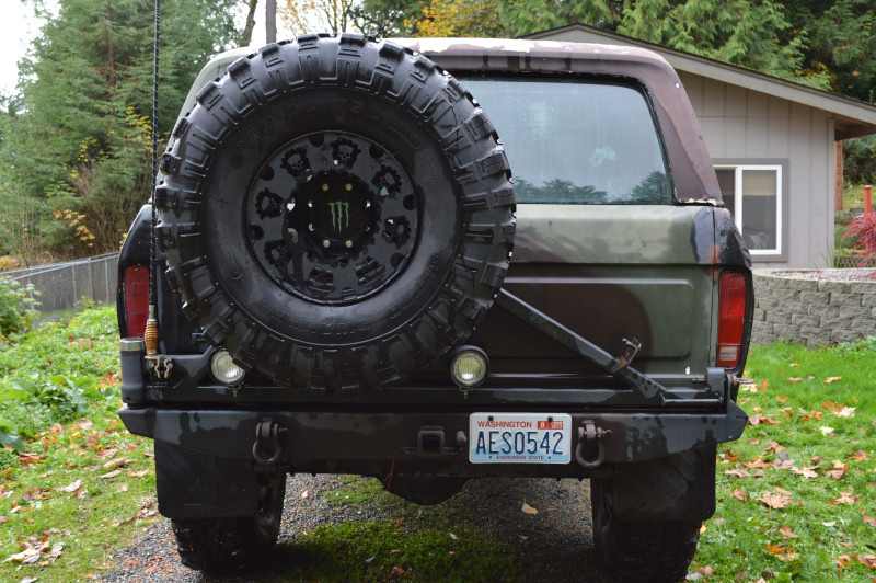 Rear view of a 1989 Ford Bronco with spare tire and camouflage paint