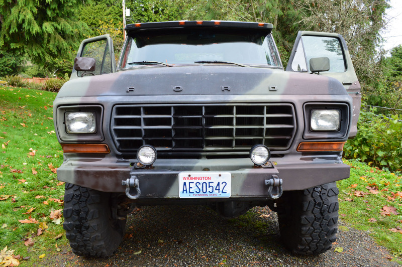 Camouflaged Ford truck front view, doors open, Washington license plate AES0542