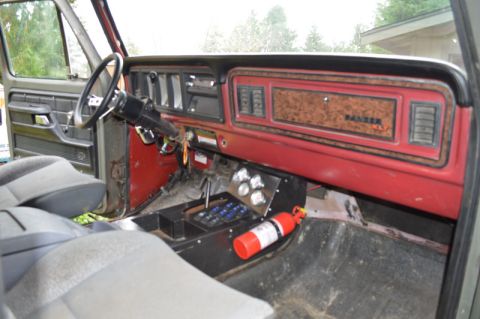 1989 Ford Bronco - The interior of a 1979 Ford F-Series truck, a dashboard with woodgrain trim and a 'RANGER XLT' badge, along with an aftermarket switch pane…
