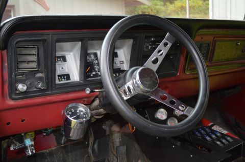 1989 Ford Bronco - The interior of this vehicle features a custom steering wheel and aftermarket gauges.