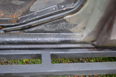 1989 Ford Bronco - Detail shot of the door sill and step area on a vehicle, with visible texture and weather seal.