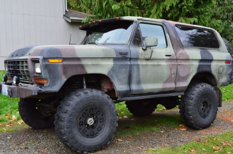 1989 Ford Bronco - This 1978 Ford Bronco features a camouflage paint scheme and significant off-road modifications.