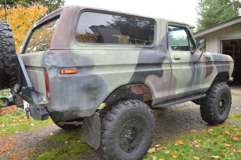 1989 Ford Bronco - This 1978 Ford Bronco is shown from a three-quarter front angle, a camouflage paint scheme and off-road tires.
