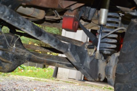 1989 Ford Bronco - Close-up view of the suspension and axle assembly of an off-road vehicle.