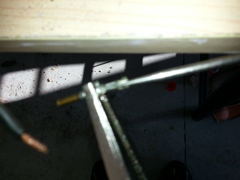 1994 Ford Bronco - A close-up view of a throttle body cable linkage being worked on, with tools and wiring visible.