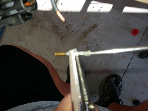 1994 Ford Bronco - Working on a vehicle component, possibly a throttle body, with tools.
