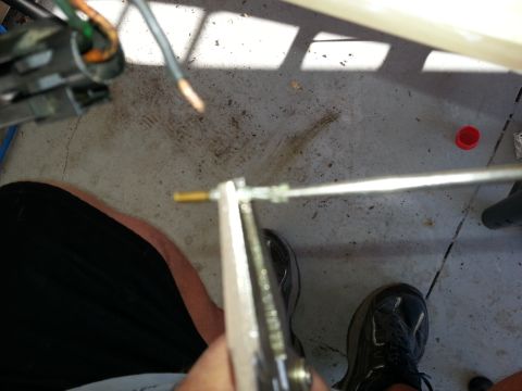 1994 Ford Bronco - A close-up view shows a throttle body component being worked on with a tool and electrical wires.